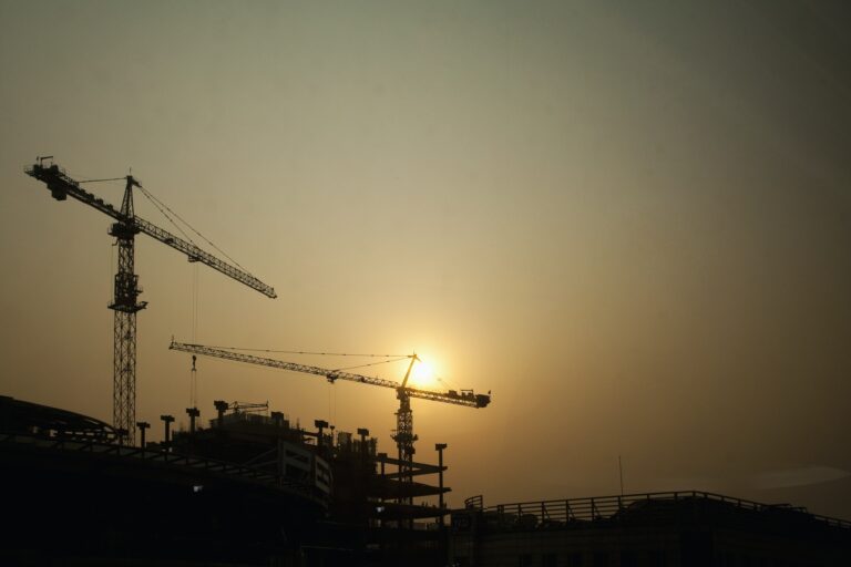 Crane on construction site at sunset.